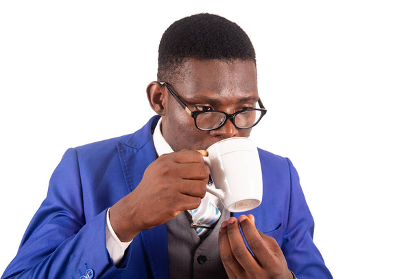 young businessman in jacket standing isolated on white background drinking coffee - Photo, Image