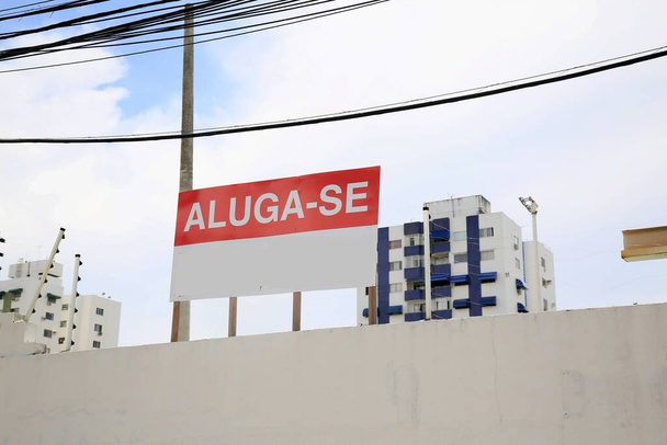 salvador, bahia, brazil - december 23, 2020: rent sign up is seen on a wall of a condominium in the neighborhood of imbui in the city of Salvador. *** Local Caption *** - Photo, Image