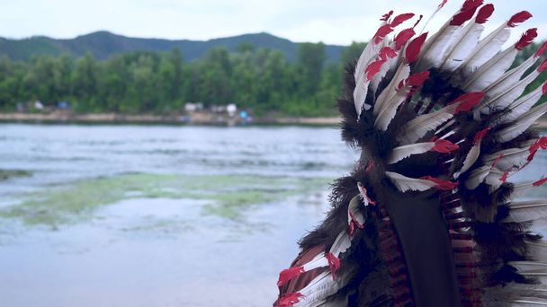 Old Native American Indians stands on the background of the river. - Photo, Image