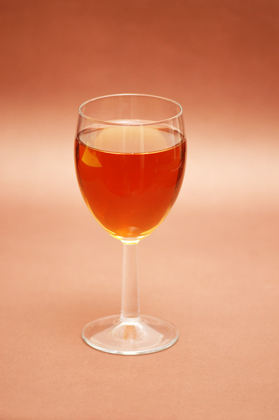 Glass of liqueur over the biege background - Photo, Image