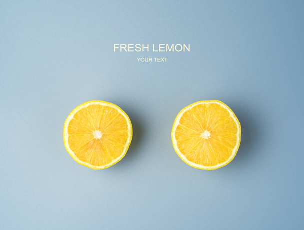 Two halves of a ripe juicy lemon on a gray background. - Photo, Image