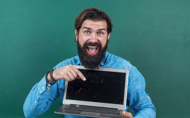 man with beard and moustache look as businessman or teacher in college or school, online shopping - Fotó, kép