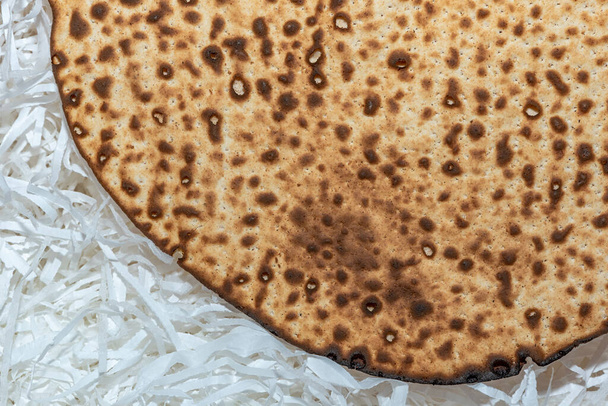 Matzo texture, a top view of a piece of traditional wheat dry bread served on Hebrew Passover. baked matzo, matzo texture, background. - Photo, Image