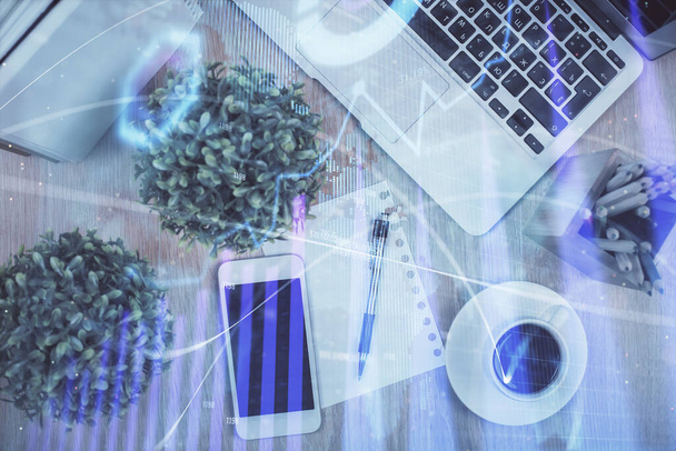 Multi exposure of financial chart hologram over desktop with phone. Top view. Mobile trade platform concept. - Fotografie, Obrázek