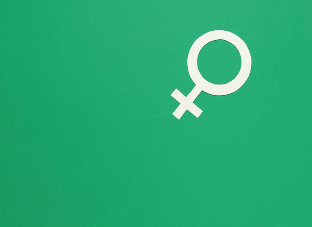 Woman gender symbol on green background. Top view. Minimalism. Gender equality - Photo, Image