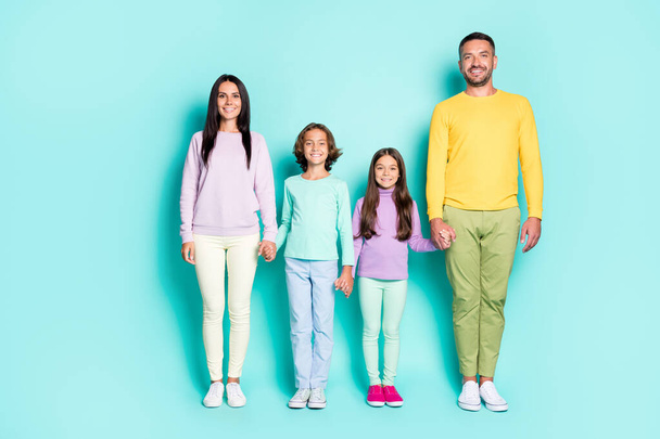 Photo portrait of big family holding hands isolated on vivid cyan colored background - Foto, afbeelding