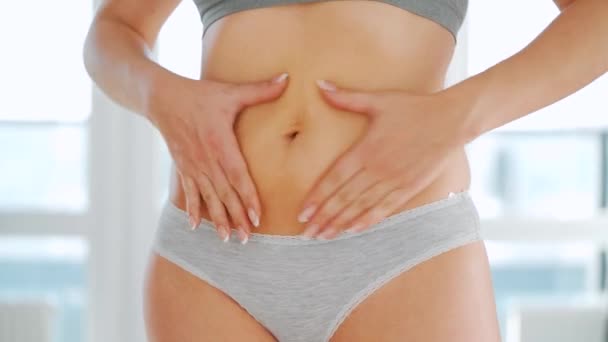 Woman smears her stomach with stretch marks gel and does self-massage - Footage, Video