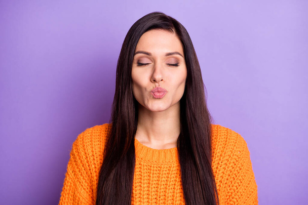 Portrait of attractive lovable dreamy long-haired girl sending air kiss isolated over vibrant violet color background - Photo, image