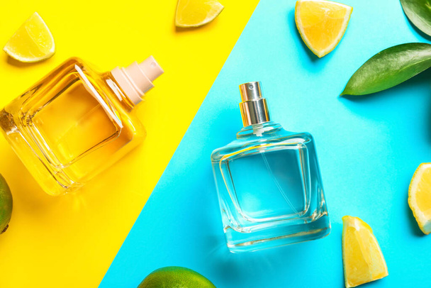 Bottles of citrus perfume on color background - Photo, Image