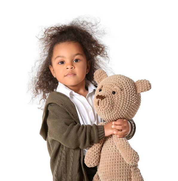 Cute African-American baby girl with teddy bear on white background - Фото, зображення