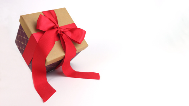 Cardboard box with a red bow. Isolated on white background. Place for your text. Copy space. - Photo, Image