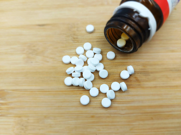 кальциевые таблетки на деревянном фоне - Фото, изображение