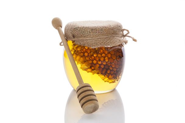 Honey jar with wooden dipper. - Foto, Imagem