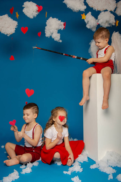 Two cute boys and a girl of angels on Valentine's Day - Фото, зображення