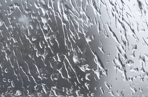 Drops of frozen water on a window glass in winter - Photo, Image