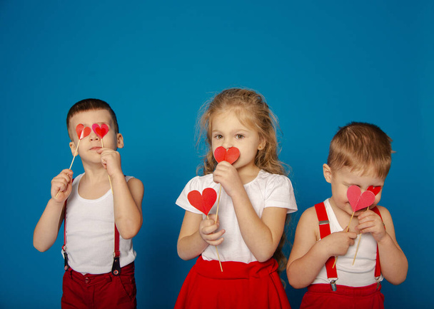 Three cute baby on a blue background on Valentine's Day - Foto, Imagem