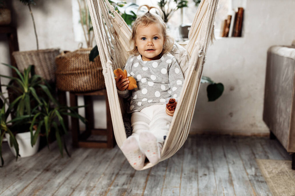 little girl relaxing on the swing at home  - Foto, imagen