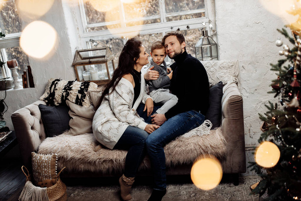 happy family in christmas decorated  room on sofa  - Foto, Imagen