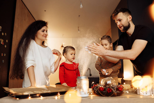 happy family baking cookies in the kitchen at home - Foto, Bild