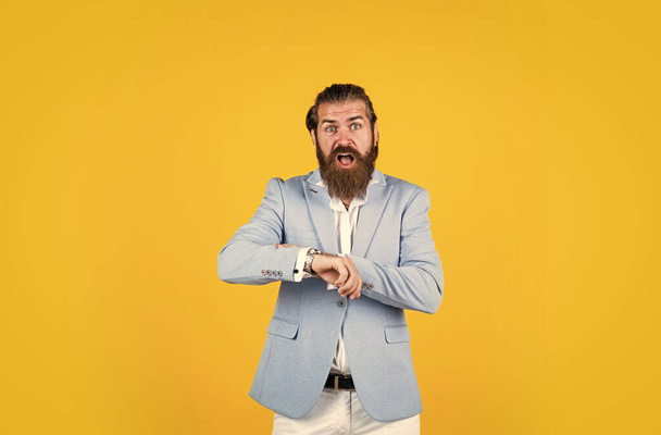 oh my god. shocked bearded man having late. Confident and successful. stylish man. bearded stylish businessman. Handsome confident man with perfect hairstyle. fashion model wear jacket - Foto, afbeelding