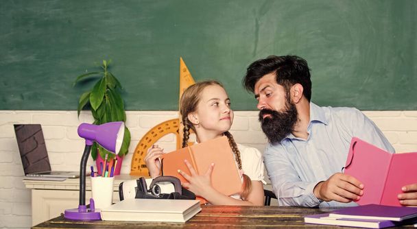 Following example. Girl pupil study with bearded teacher. Studying methods for children. School education. Extra classes. Cognitive skills concept. Schoolgirl likes study with father. Study hard - Фото, зображення