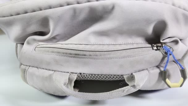 hand unzips and zips black nylon sport backpack bag. - Footage, Video
