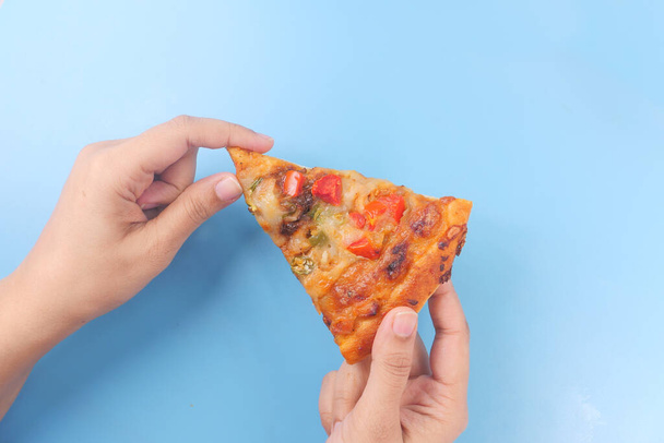 hand holding a slice of cheese pizza on color background  - Photo, Image