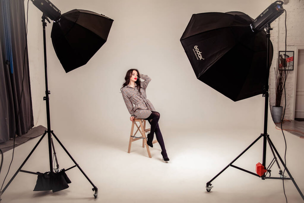 Sexy man and woman doing a fashion photo shoot in a professional studio. - 写真・画像
