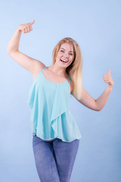 Happy positive young beautiful woman having great mood wearing blue top fashionable outfit - 写真・画像