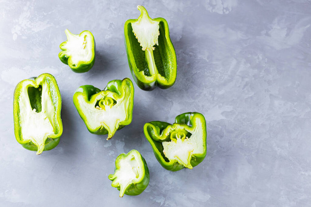 Ugly bell pepper on ultimate gray background. Sliced bell pepper halves on the table. Concept - reduction of food organic waste. Non GMO vegetables. Copy space. Top view - Φωτογραφία, εικόνα