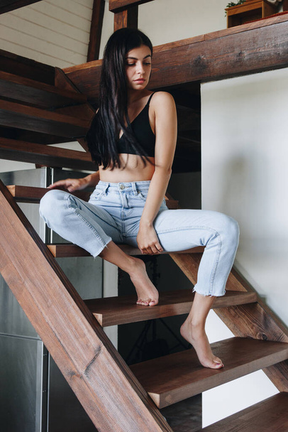 Beautiful young woman wearing jeans at home - Foto, imagen