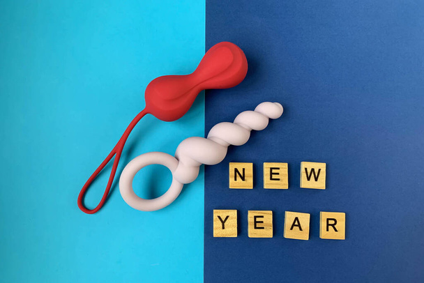 Sex toys and new year.  Jiggle balls and butt plag. Inscription NEW YEAR. Useful for adult, sex shop - Foto, afbeelding