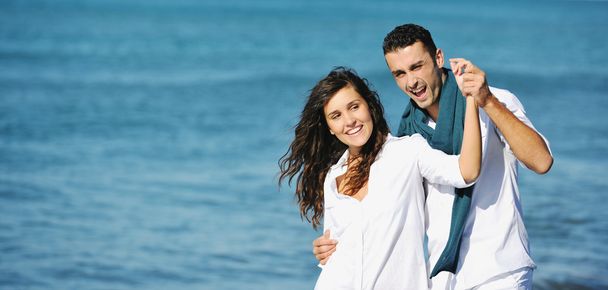 Happy young couple have fun at beautiful beach - Foto, immagini