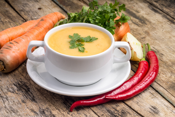 Organic food. Pea soup with vegetables around on wood background - Valokuva, kuva