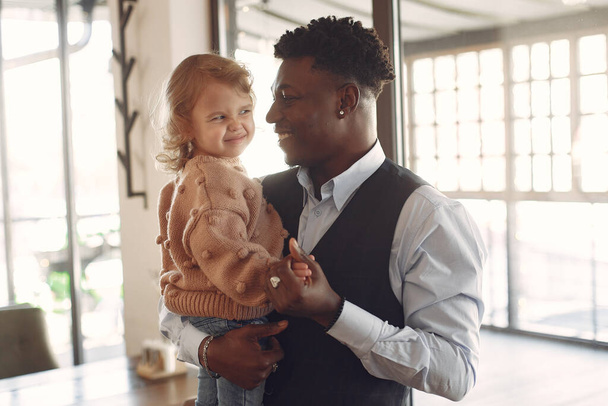 Black man with white daughter standing in a cafe - Valokuva, kuva
