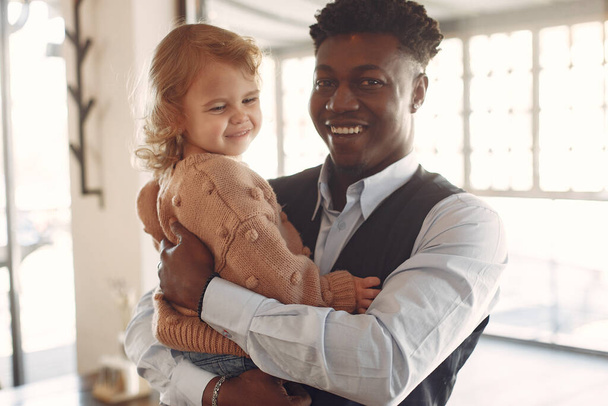 Black man with white daughter standing in a cafe - Valokuva, kuva