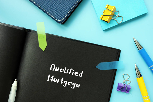 Financial concept meaning Qualified Mortgage with inscription on the piece of paper - Photo, Image