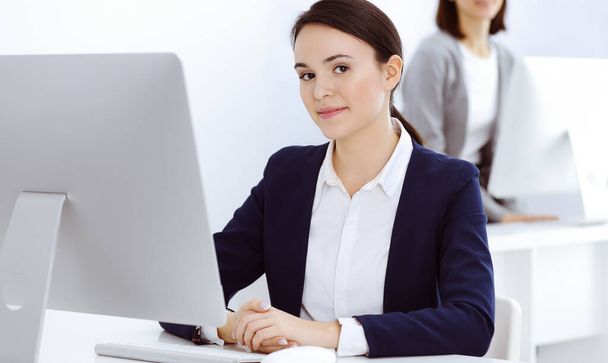 Businesswoman working with computer in office. Lawyer or accountant sitting at work, headshot. Business concept - Фото, зображення