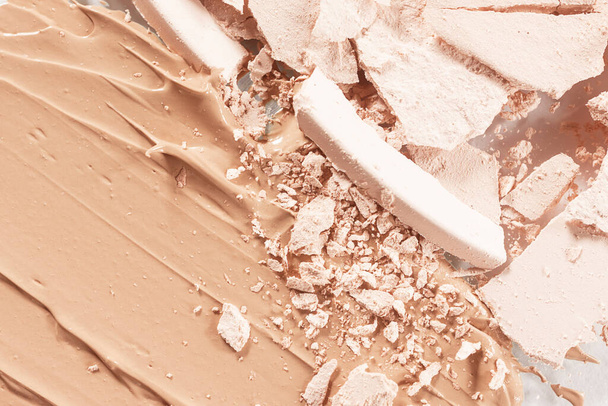 Loose light powder and smear of foundation close-up. The concept of decorative cosmetics, makeup. Advertising macro photography.	 - Foto, afbeelding