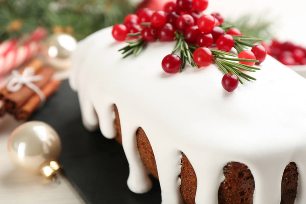 Traditional classic Christmas cake decorated with cranberries and rosemary on table, closeup - Photo, image