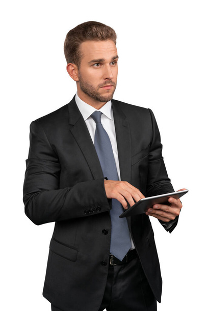 Businessman in black suit and tie with tablet isolated over white background - Foto, Imagem