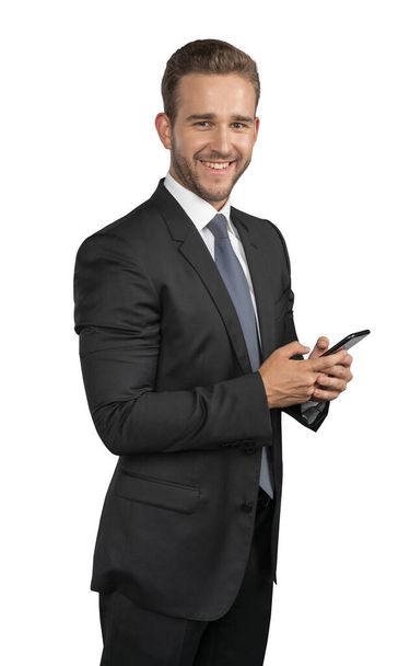 Empresario en traje y corbata con teléfono aislado sobre fondo blanco - Foto, Imagen