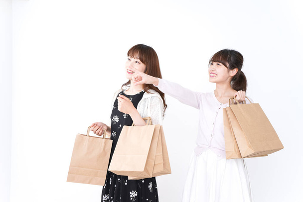 two women with shopping bags on white background  - Foto, immagini