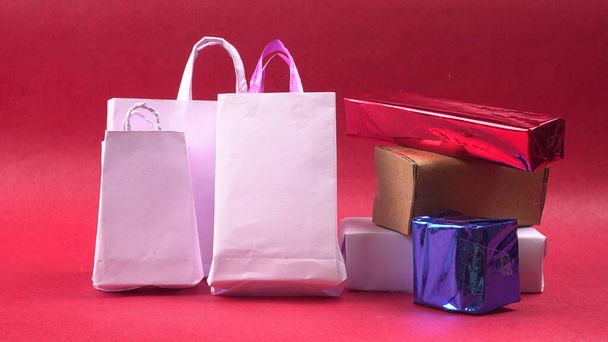 Confezioni regalo e borse in carta artigianale il concetto di regali fatti a mano su sfondo rosso. - Foto, immagini
