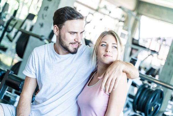 Couple men and women happy enjoying exercise in sport gym fitness club caucasian love couple - Photo, Image