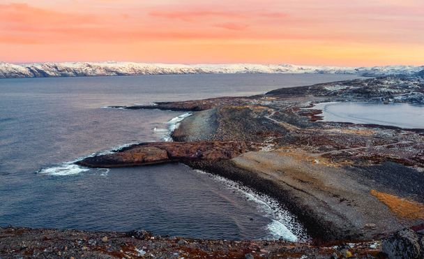 A rock cliff with a tidal shoreline. Wonderful panoramic mountain landscape on the Barents sea. Teriberka. Russia. - Photo, Image
