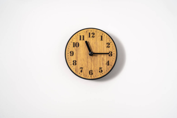 wood office wall clock with white dial on white background. wall clock on white background, top view. - Photo, Image