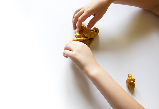 Little girl playing with the gold slime. Sensory activity for child. - Photo, Image