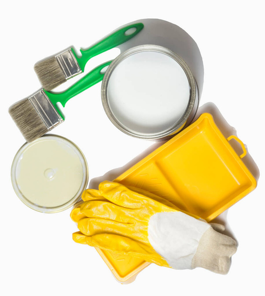 paint in an iron pot, paint tray and brushes with yellow Gloves. - Photo, Image