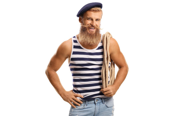 Bearded smiling sailor holding a rope on his shoulder isolated on white background - Foto, Imagen